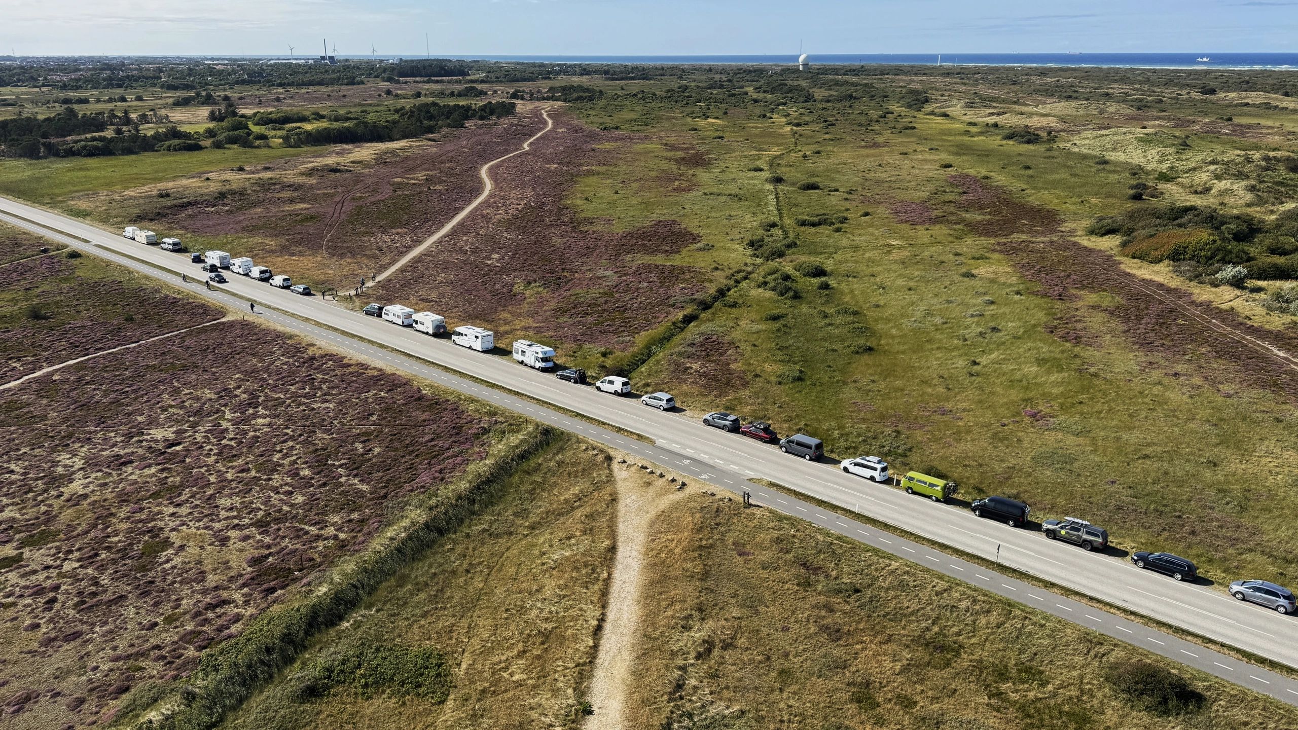 Recreational vehicles lined up in an outdoor parking area